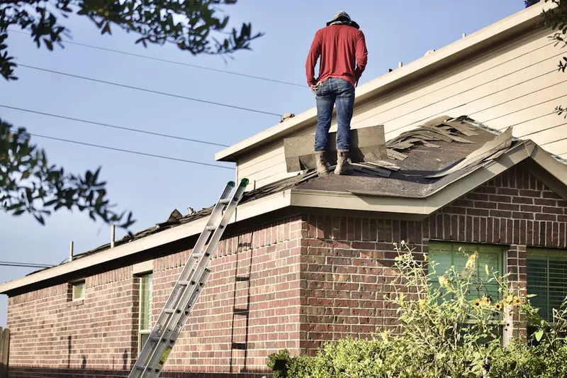 Professional roofer working on a residential roof in Cameron Station
